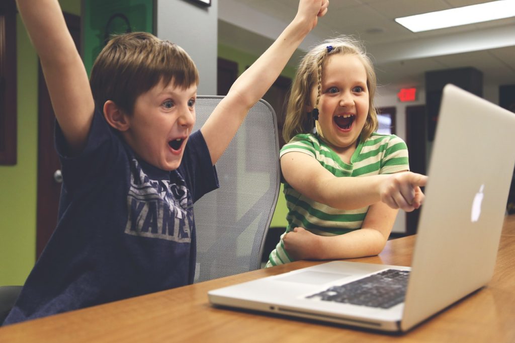 Talk to Heidi | Children cheering at a computer