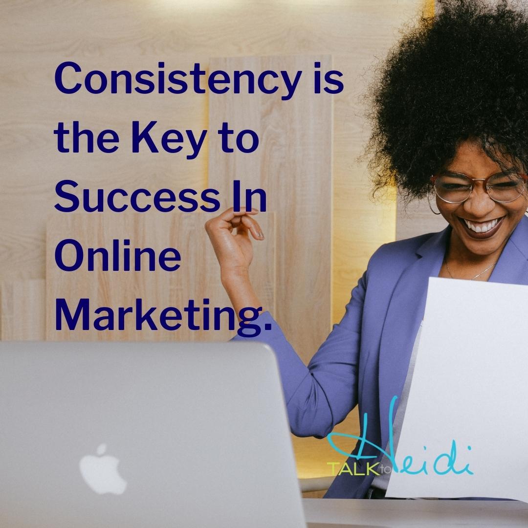 3 Lady with black hair and lavender jacket celebrating a win into front of a computer with the saying Consistency is the key to success in online marketing